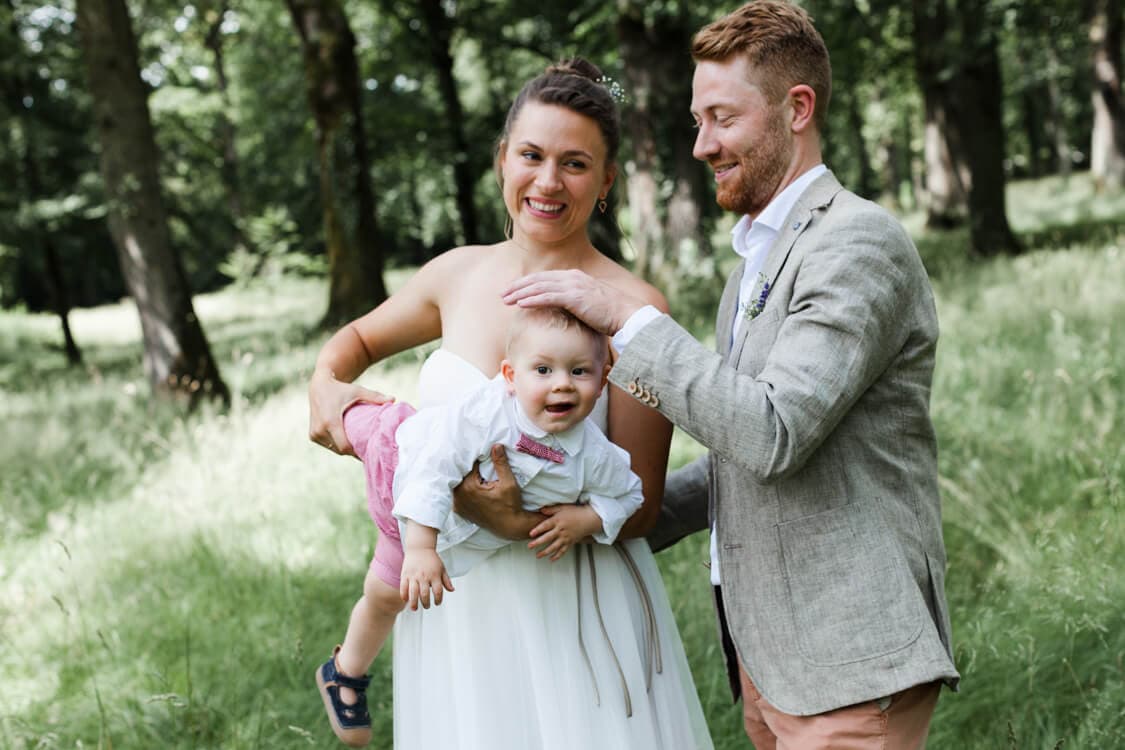 Brautpaar albert mit ihrem kleinen Sohn auf dem Arm rum