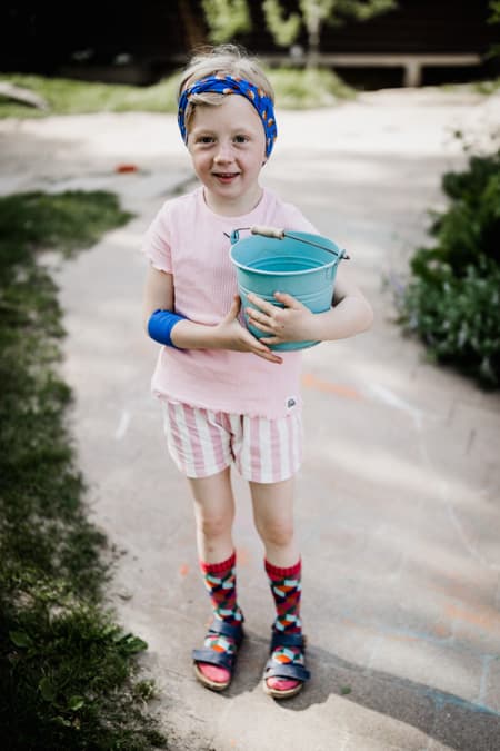 Maedchen mit Eimer unterm Arm