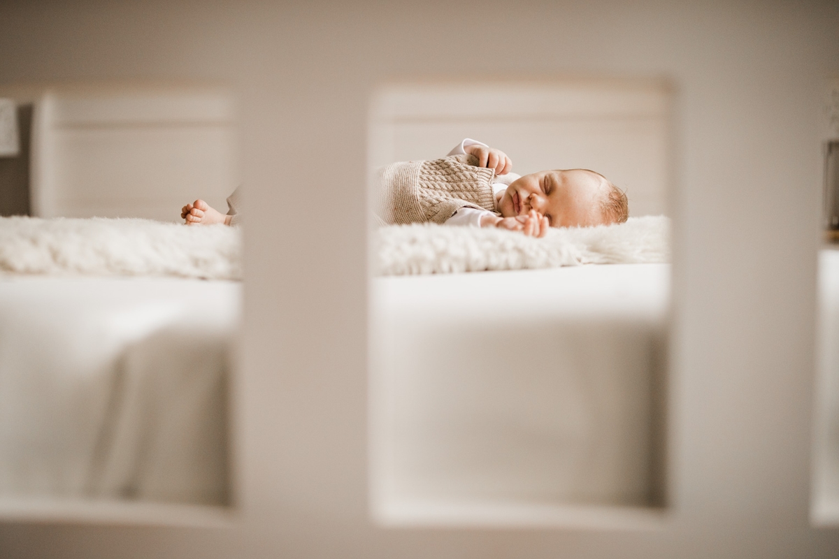 Baby liegt auf einem Bett