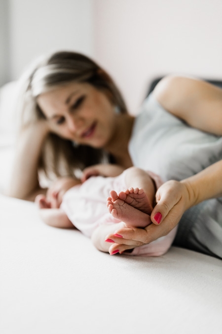 Mutter hält Füße vom Baby in den Händen